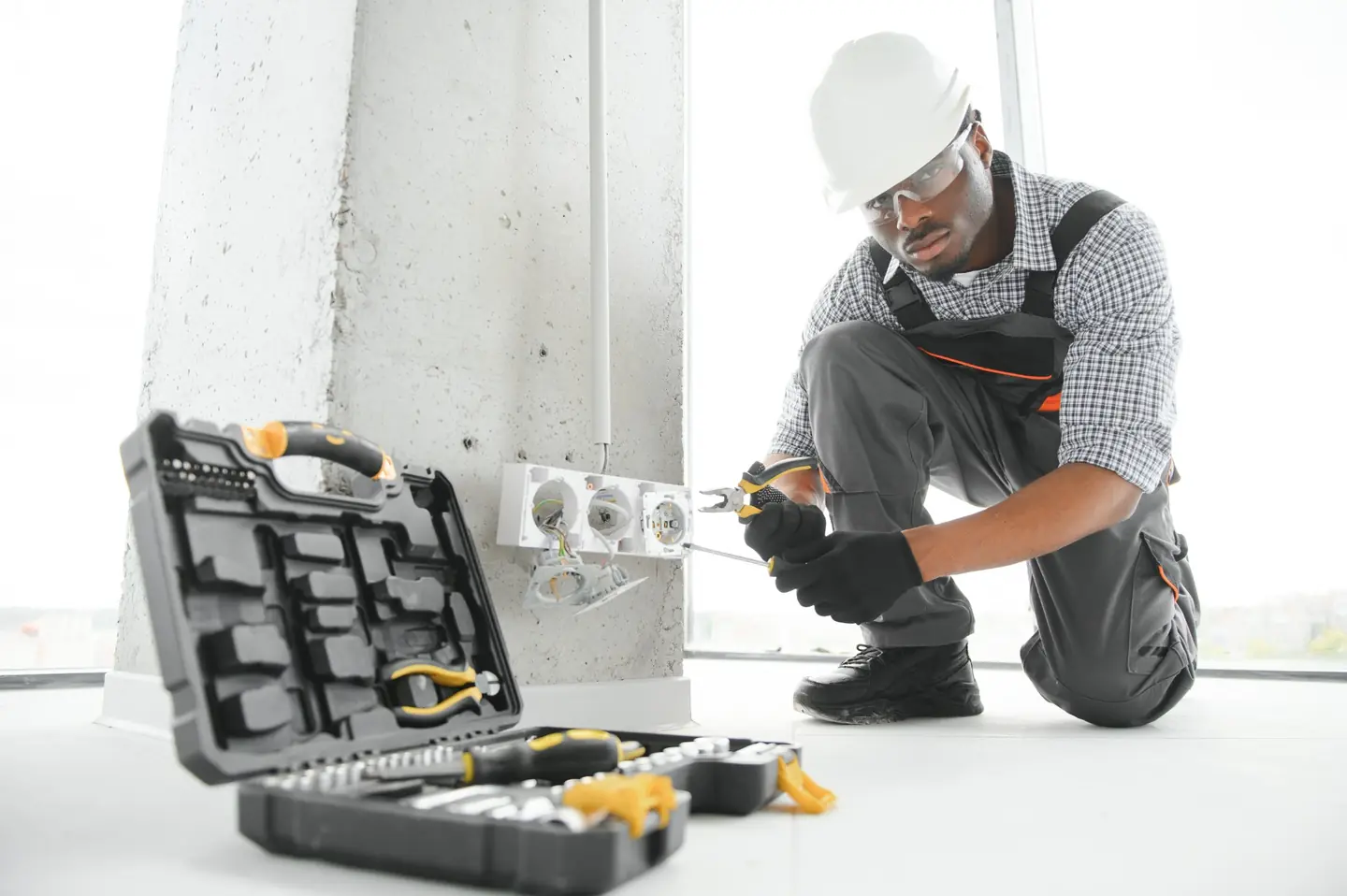 Residential electrical repairs with no separate call-out fee Residential electrician repairing a plug point at a Gauteng property